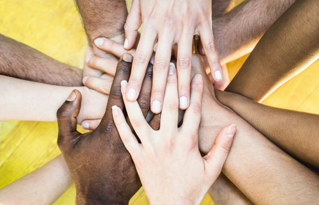 Top view of multiracial stacking hands